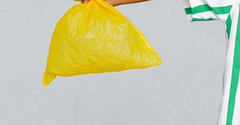Reduce Plastic - Woman in White and Green Shirt Holding Yellow Plastic Bag