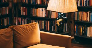 Home Library - Turned on Floor Lamp near Sofa on a Library Room