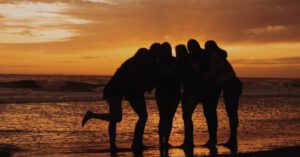 Pet-friendly Vacation - Silhouette of People Standing on Beach during Sunset