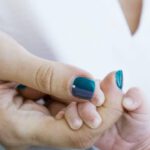 Pets New Baby - Soft focus of crop adorable newborn child hugging finger of young mother hand illustrating new family and baby protection concept