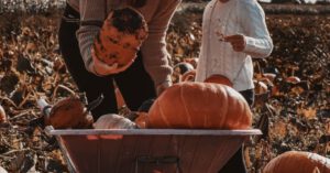 Children Vegetables - Man in White Dress Shirt Sitting Beside Woman in Orange Dress