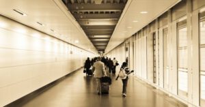 Airport Family - People Walking in the Hallway Inside the Building