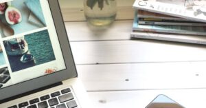 Screen Time - Macbook Air, Flower Bouquet and Magazines on White Table