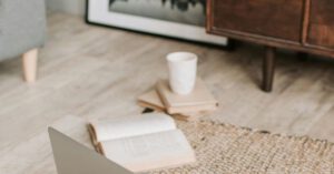 Eco Gadget - Laptop and books on floor carpet