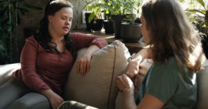Relaxed Family - Two Women Sitting on a Couch Chatting
