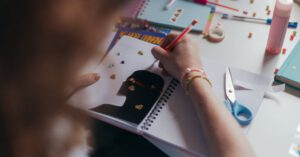 Creativity Education - Person Holding Red Pencil on White and Black Audio Mixer