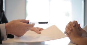 Investing Family - Crop businessman giving contract to woman to sign