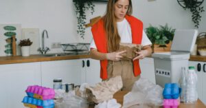 Utility Savings - Young woman sorting trash for recycling